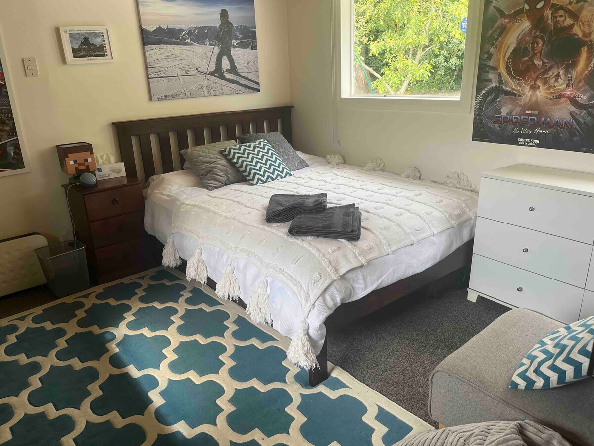 Ensuite bedroom in a cosy Sumner beach house