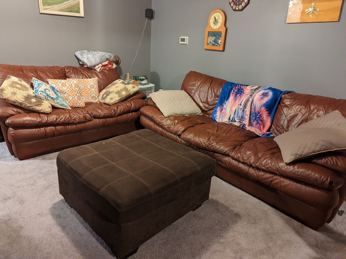 Basement Haven: Leather Sofa & Large TV