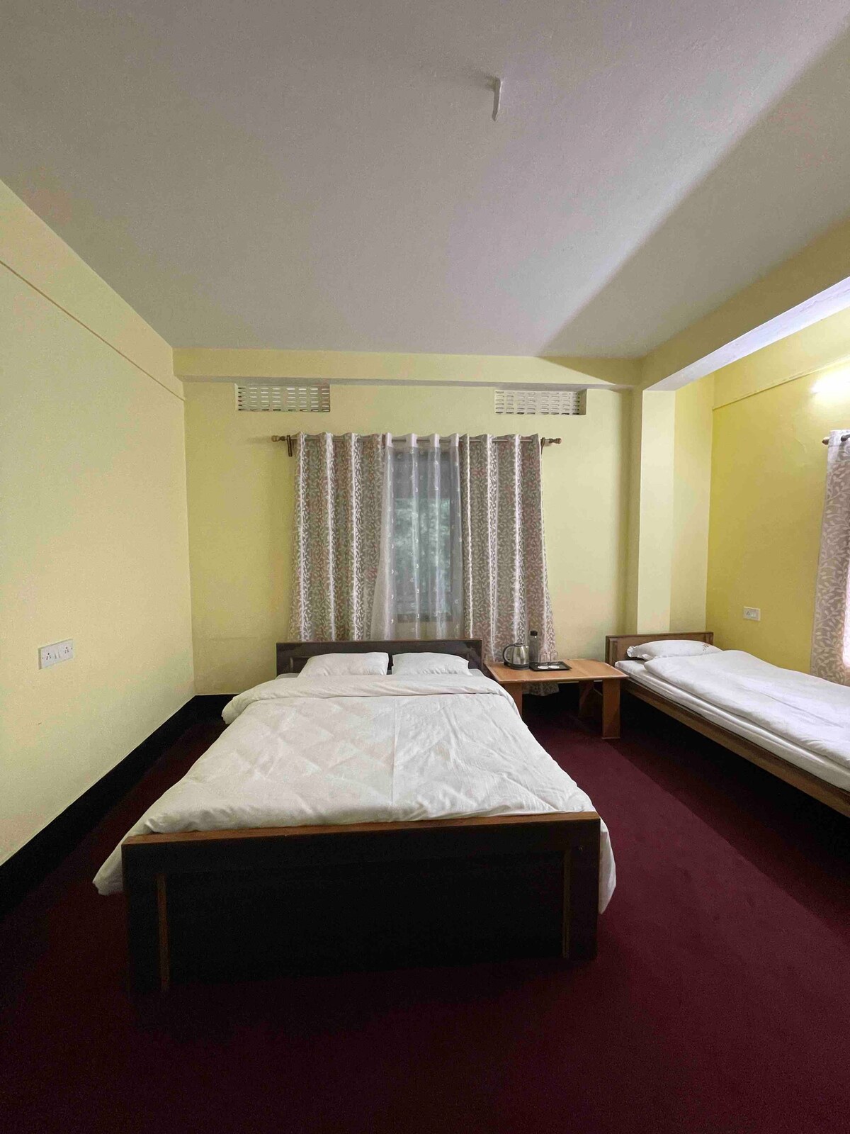 A triple bedroom with 1 double and 1 single bed.