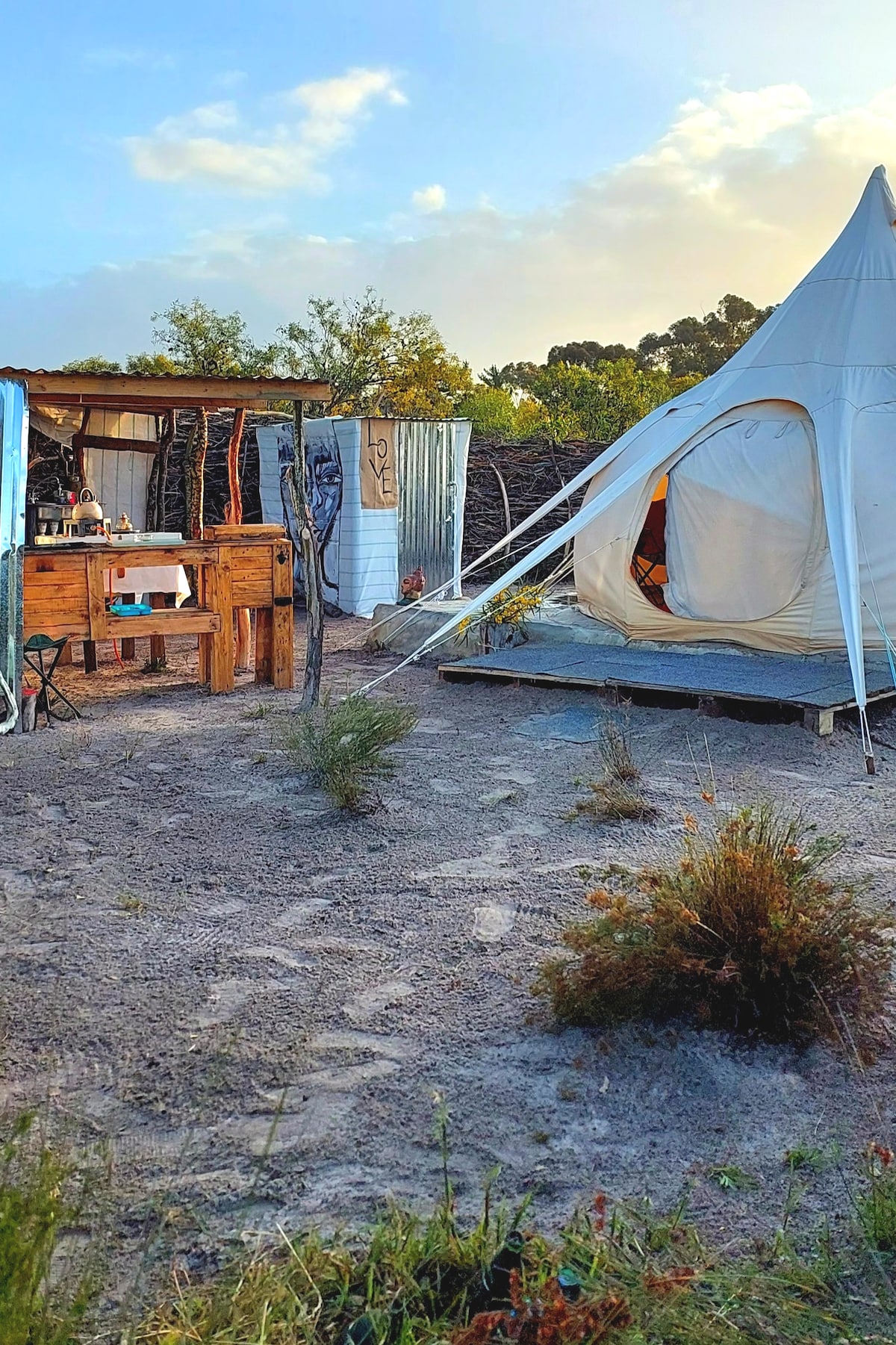 Camping tent with outdoor bathtub on artist's land