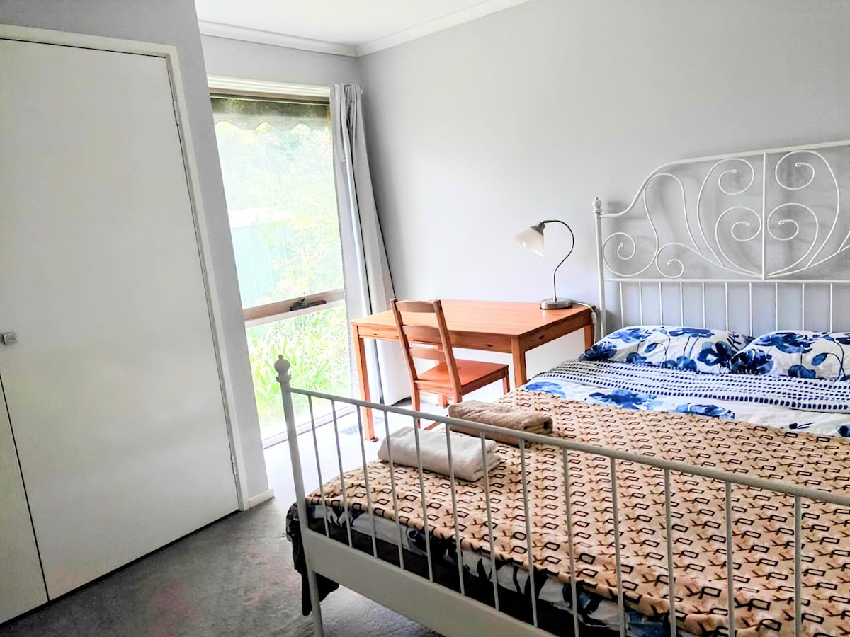 Queen bedroom with garden view and door lock