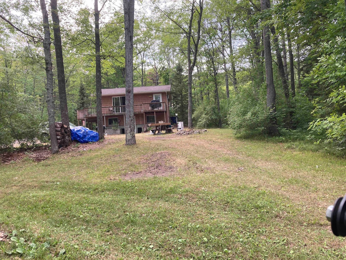 Camp Kwitchyerbelyakin with pontoon boat.