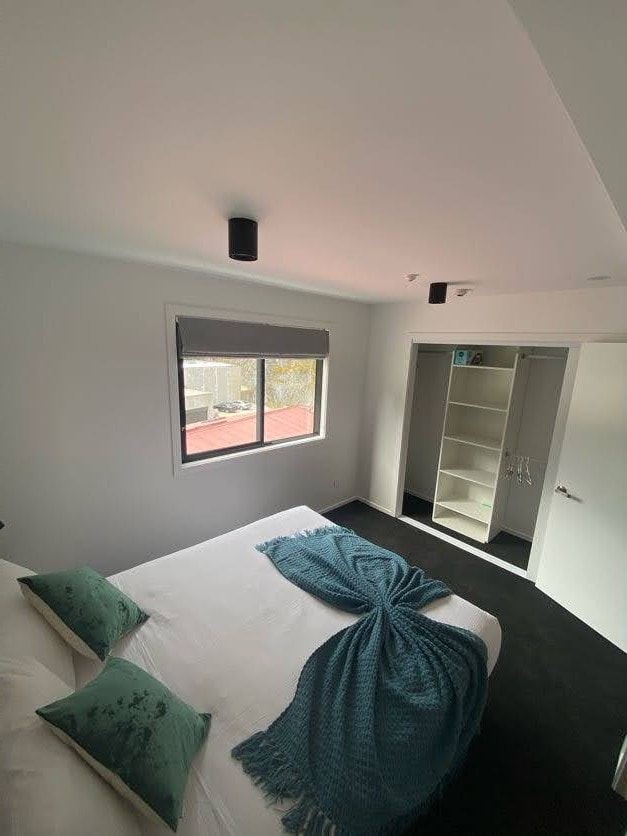 Comfy bedroom with en suite at The Alex Apartments