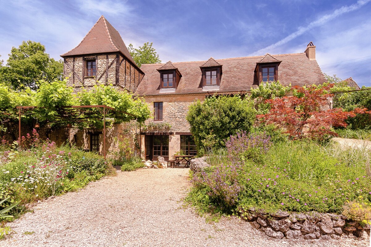 A romantic hamlet with lush gardens on a hill.