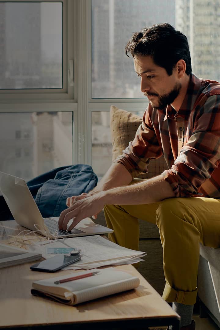 Person sitting on sofa surfing on laptop