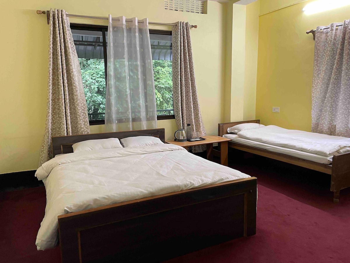 A triple bedroom with 1 double and 1 single bed.
