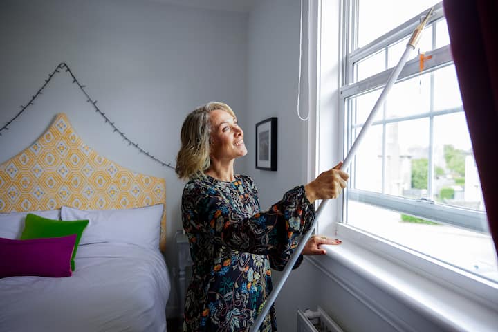 Image of Catherine opening a window