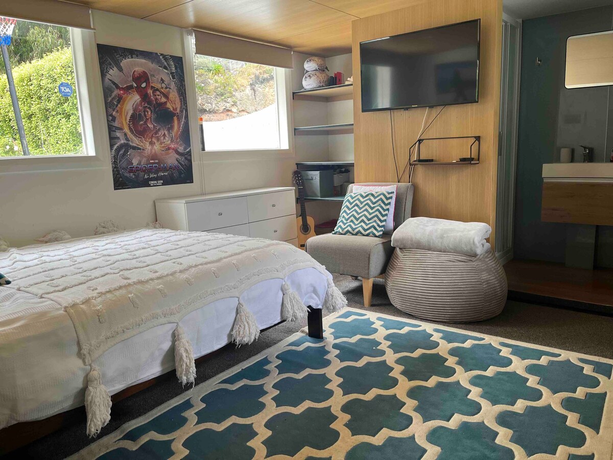 Ensuite bedroom in a cosy Sumner beach house