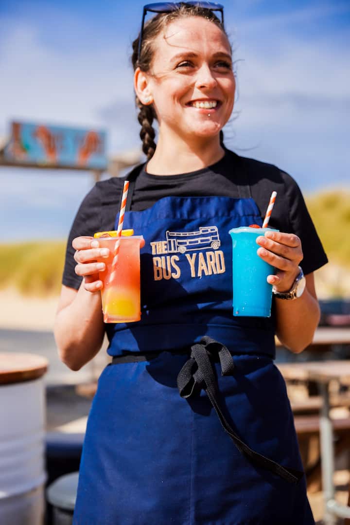 Waitress holding colourful drinks