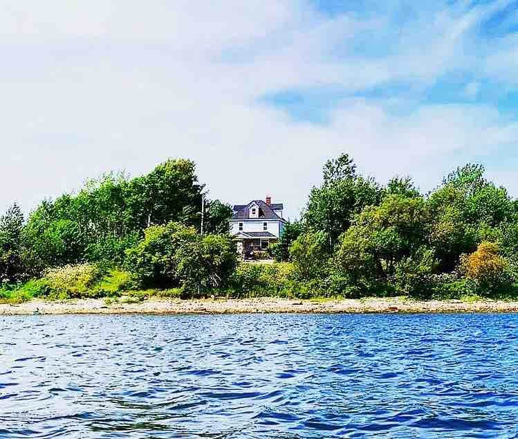 Waterfront homestead on 4 landscaped acres.