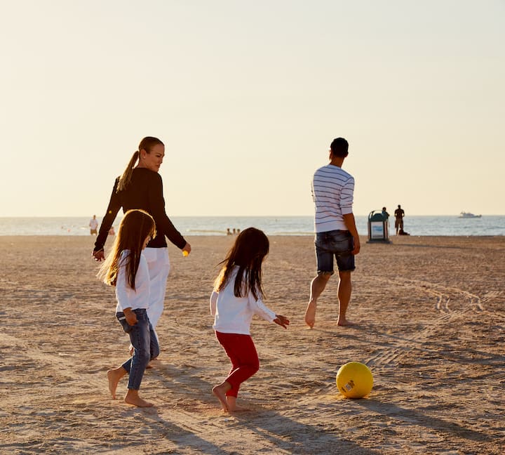 image of a family playing on the beach