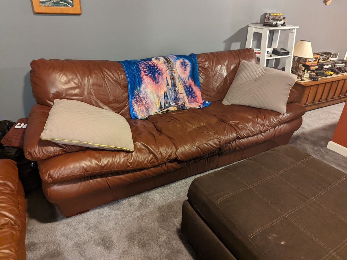 Basement Haven: Leather Sofa & Large TV