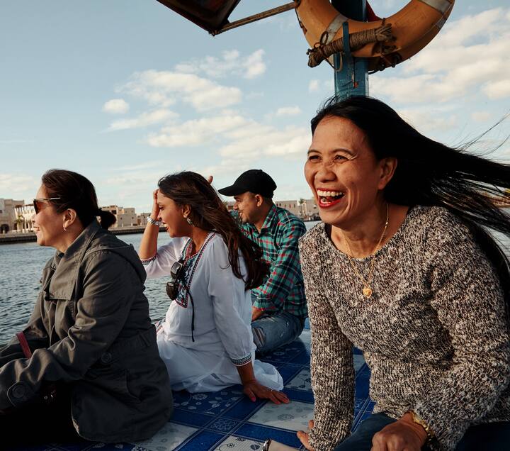 image of people smiling near the water