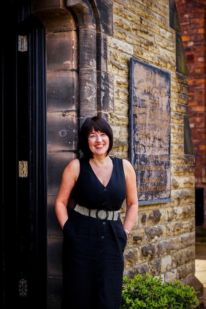 Image of Gill standing by the doorstep