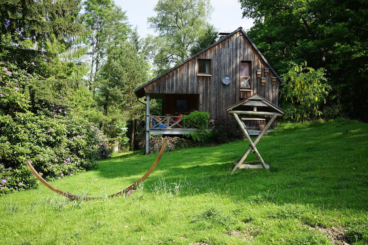 Romantisches Holzhaus am See mit Rehen im Garten