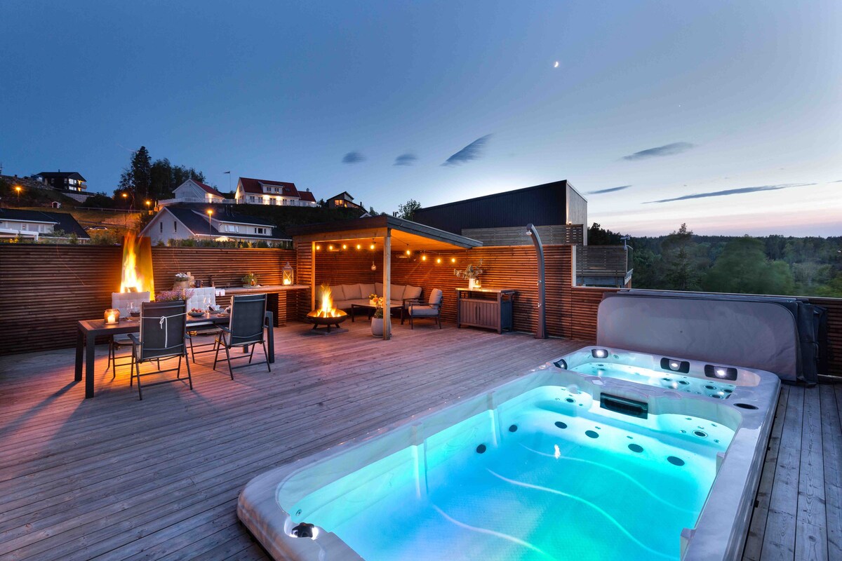 Moderne familiehus med boblebad og svømmebasseng.