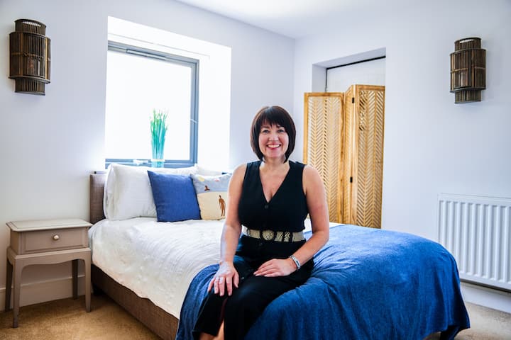 Image of Gill sitting on a bed