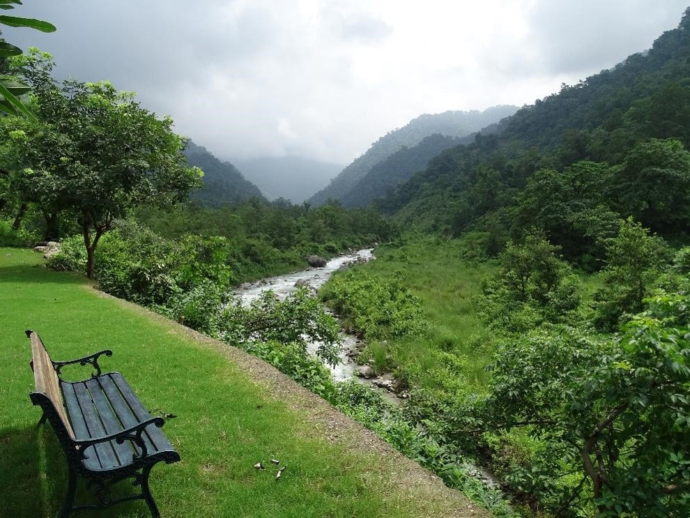 Syat House - By the River, with forested mountains