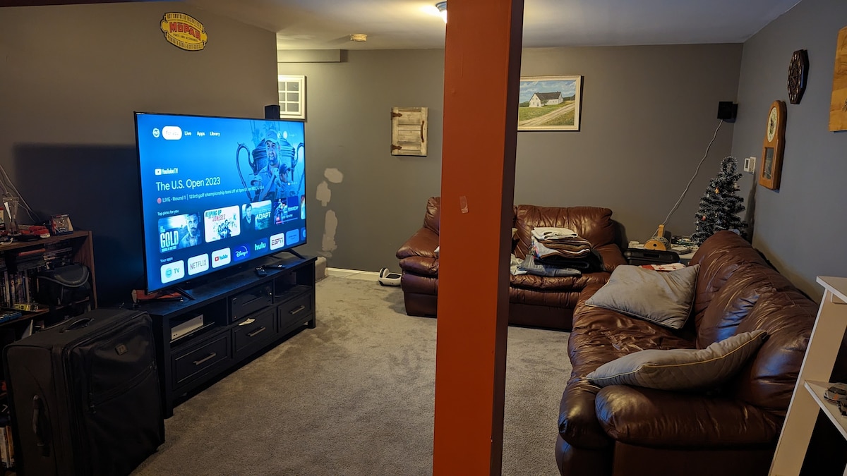 Basement Haven: Leather Sofa & Large TV