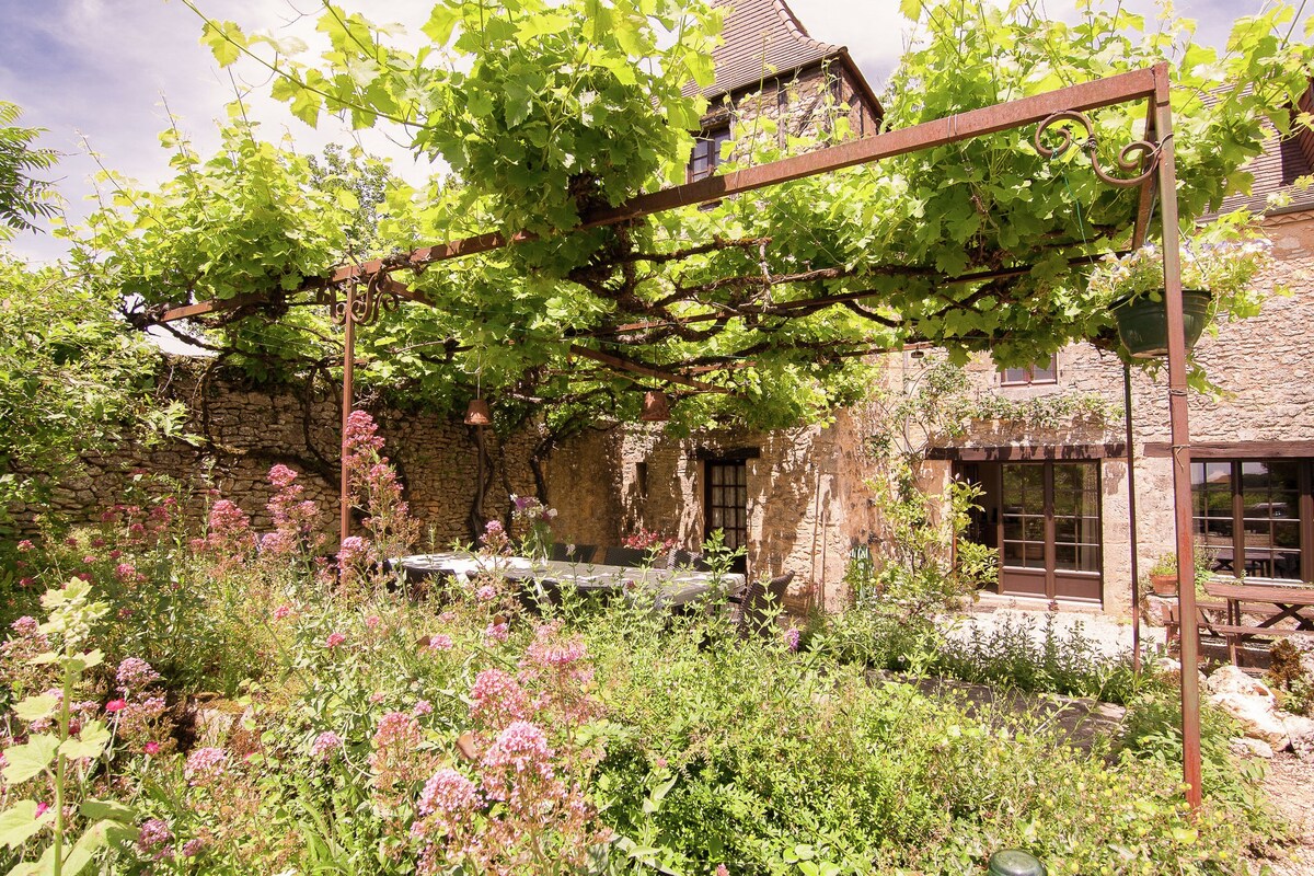 A romantic hamlet with lush gardens on a hill.