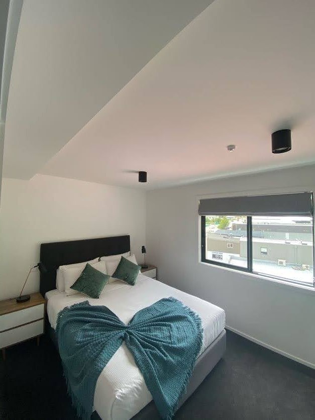 Comfy bedroom with en suite at The Alex Apartments