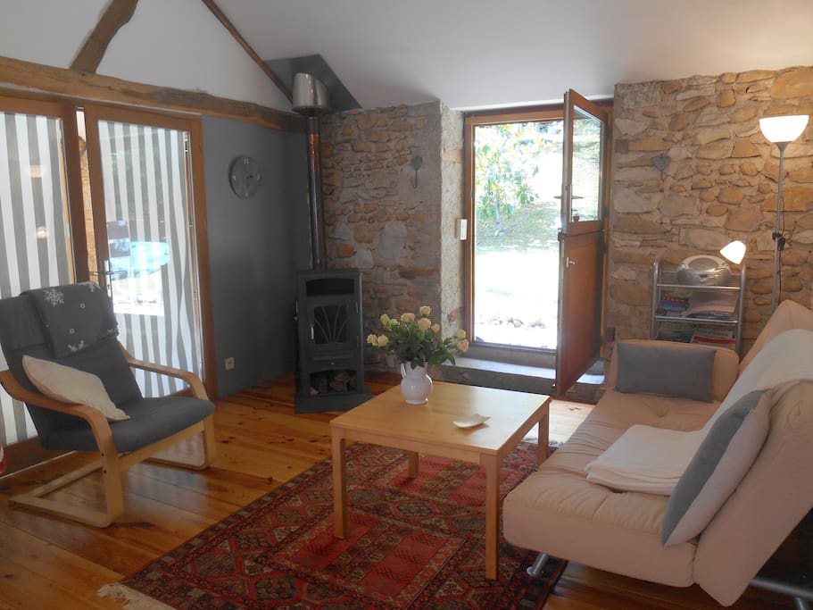 light and spacious living area with a vaulted ceiling, direct