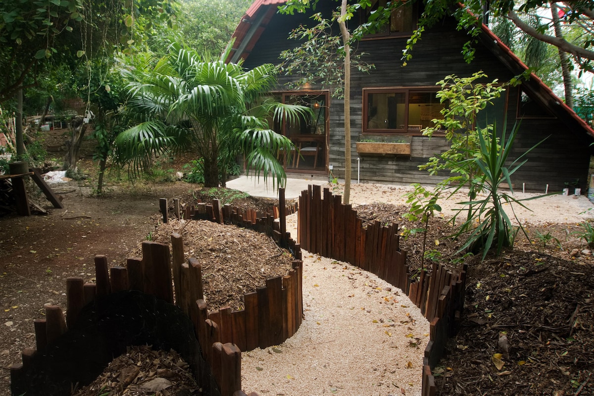 Wooden chalet in tropical garden