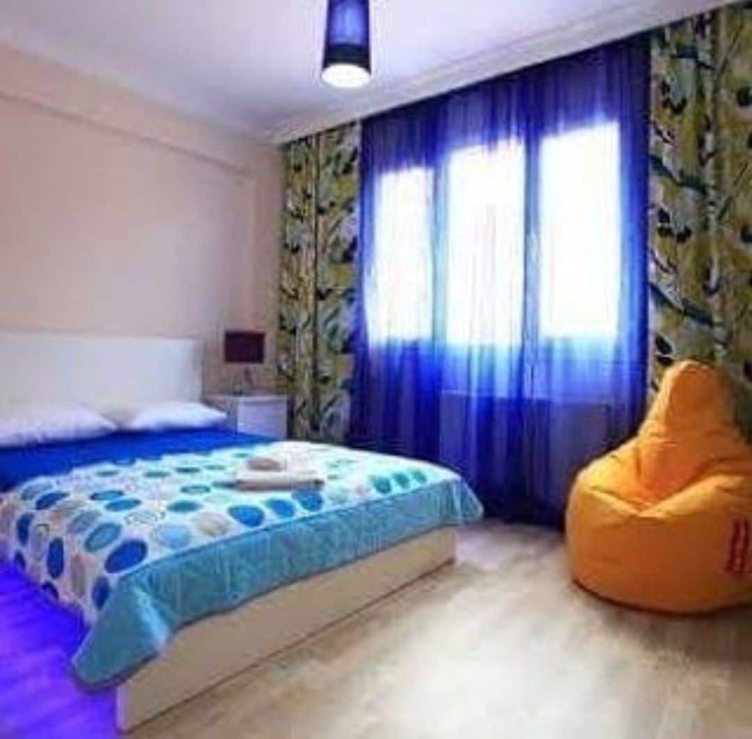 large room with large bed in the center