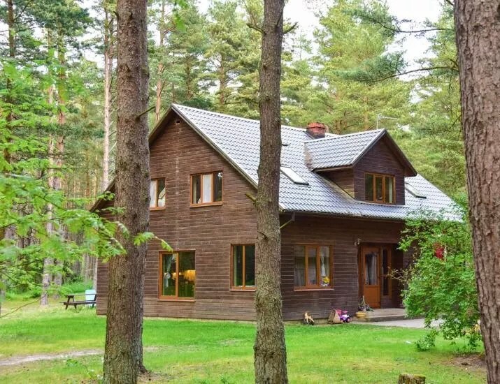 Family house in the forest steps away from sea.