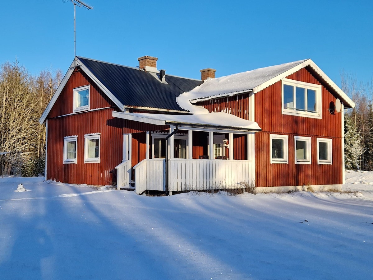 House with lake view surrounded by florest