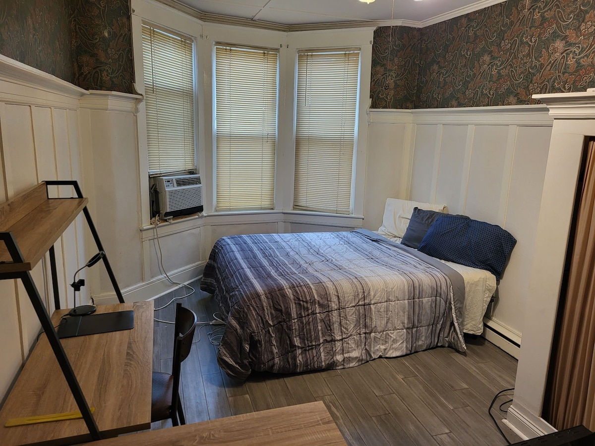 The spacious room w/ dresser/desk