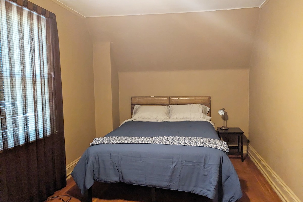 cute large room with a queen bed