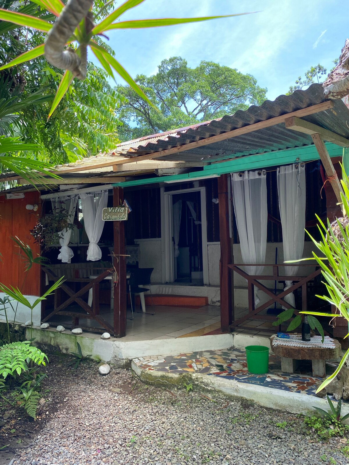 Cosy cabina in tropical garden setting