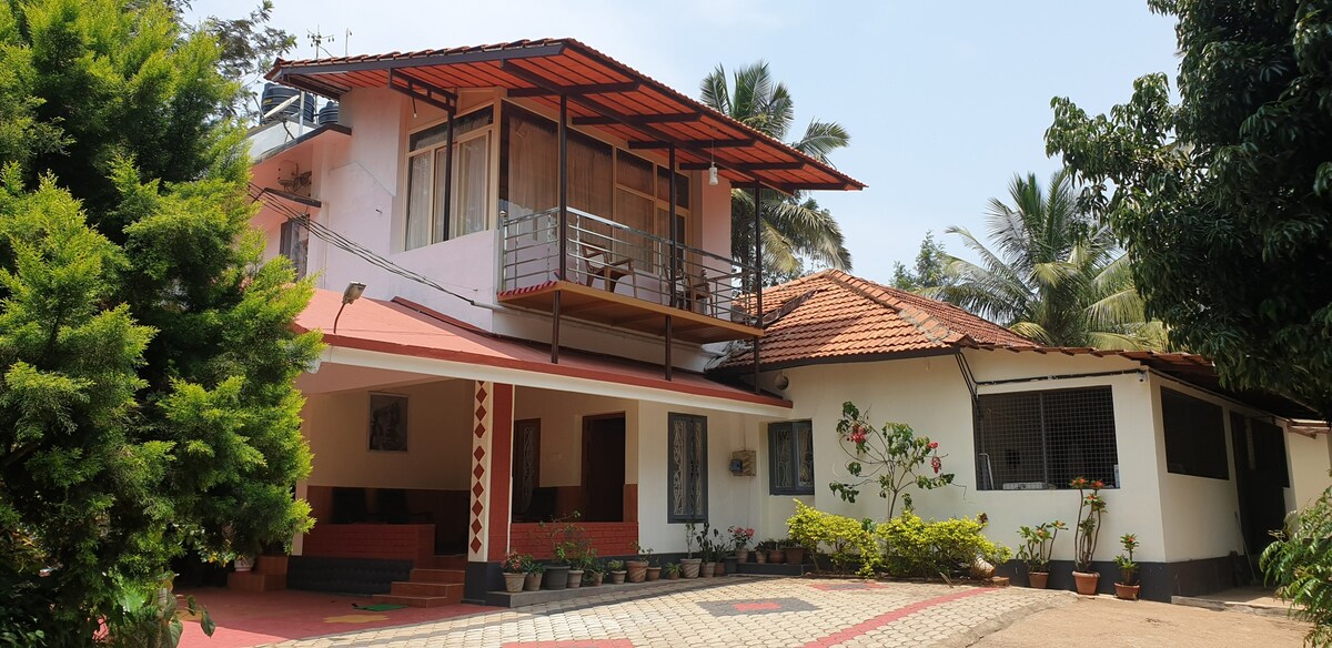 Room with balcony facing East/ Forest view.