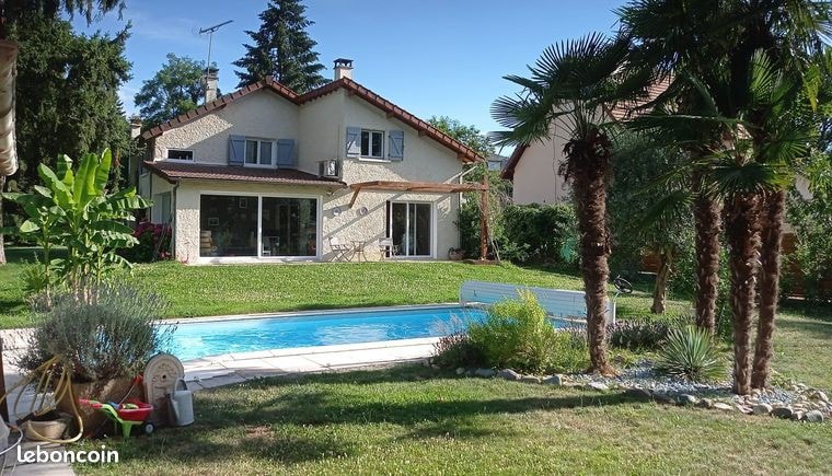 Home with flowered garden and pool in quiet area.