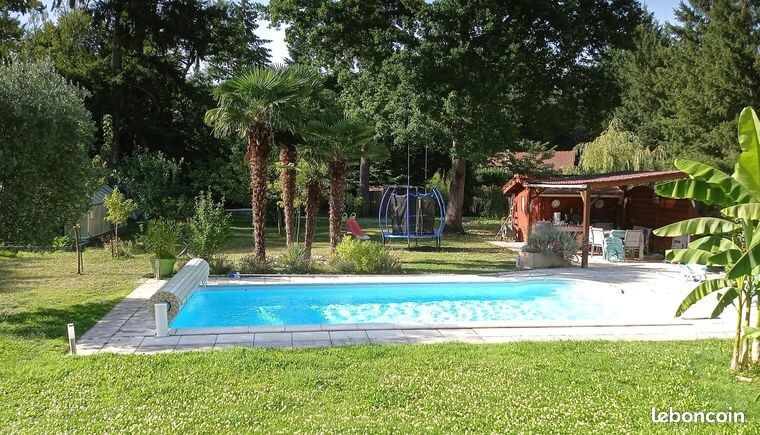 Home with flowered garden and pool in quiet area.