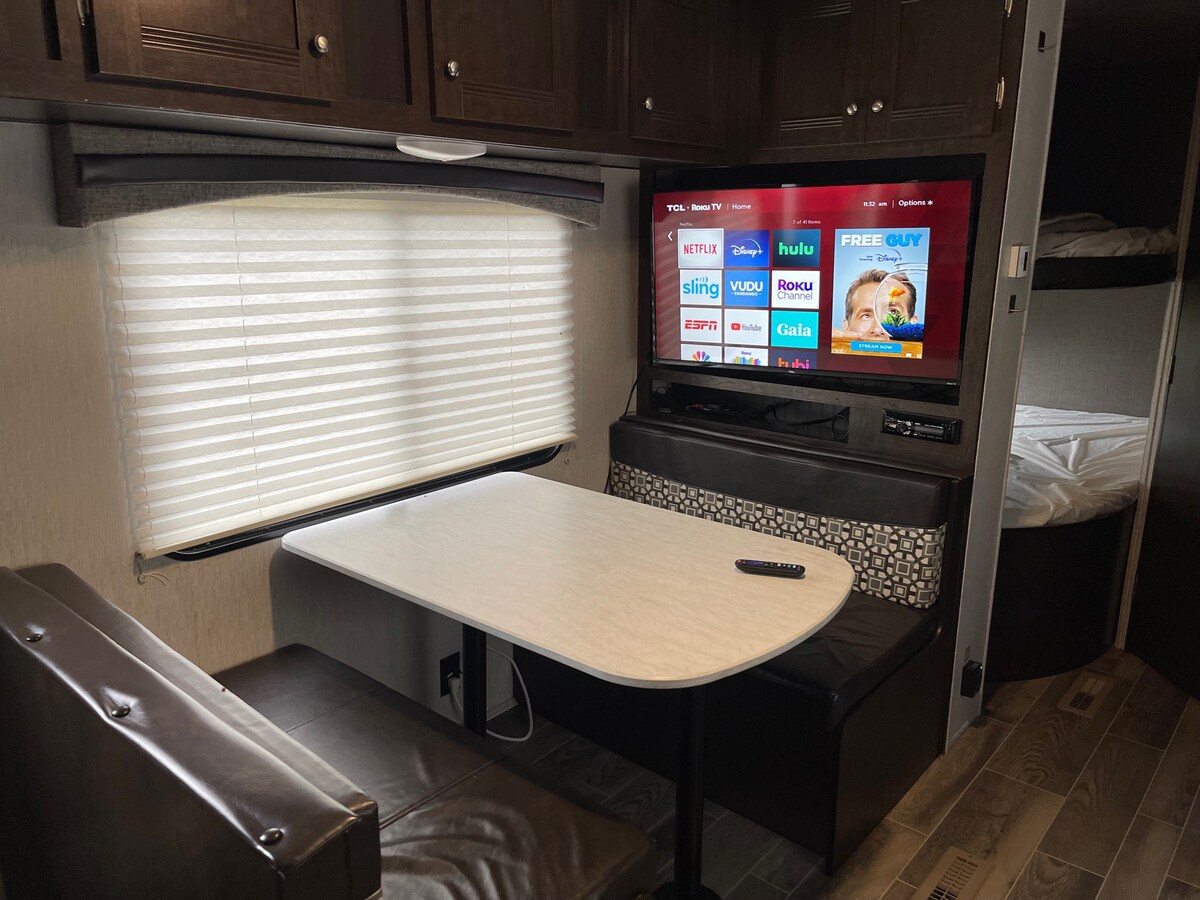 Delightful RV with campground amenities.