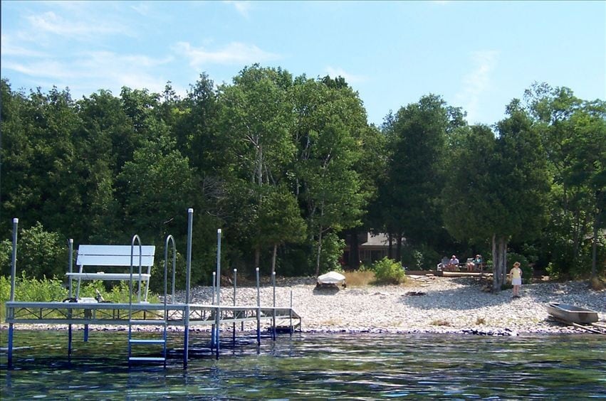 Lakeside home with 75 foot private stone beach