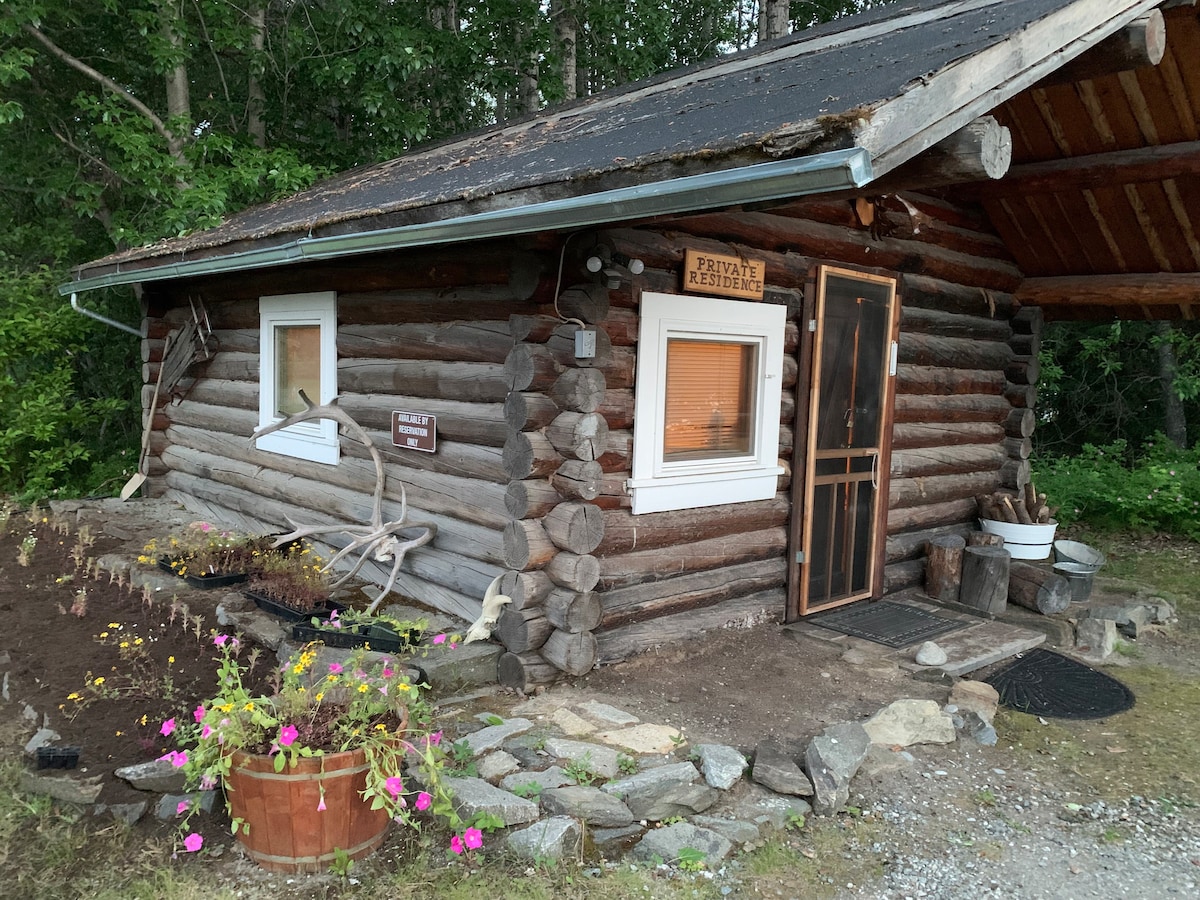 Historical Ferryman cabin on River in Alaska