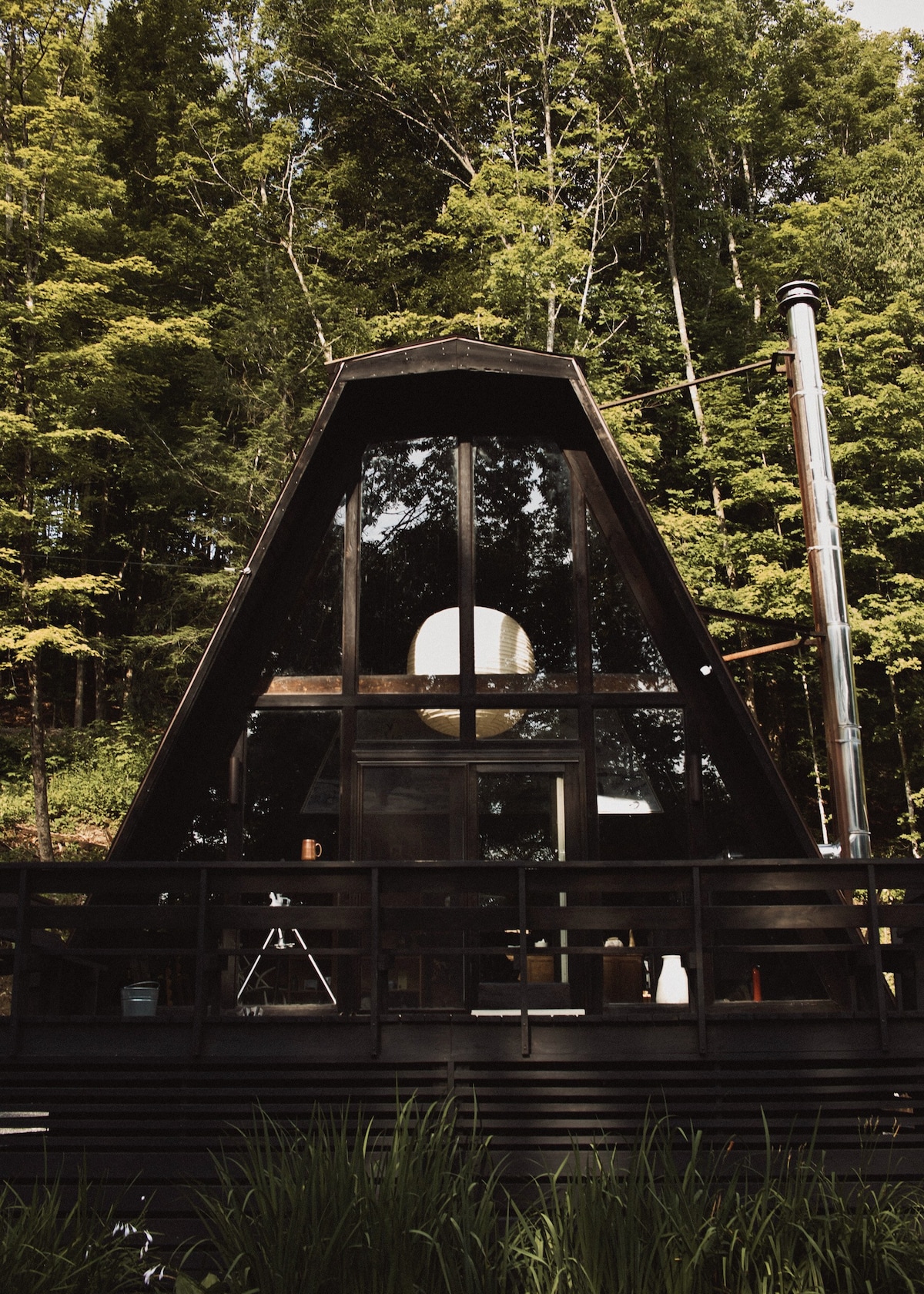 A-frame with deck and fireplace in a forest hotel