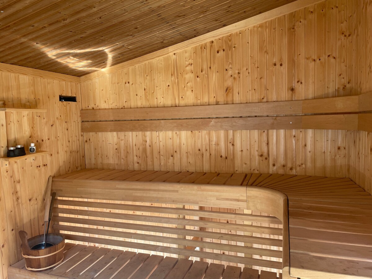 Cottage beside lake with fireplace and sauna.