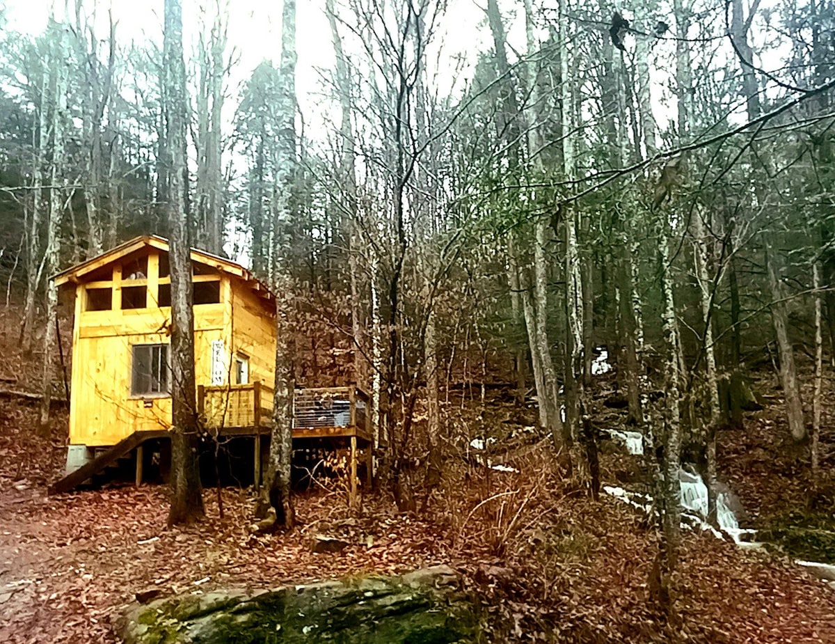 River cabin on waterfalls under the bluffs