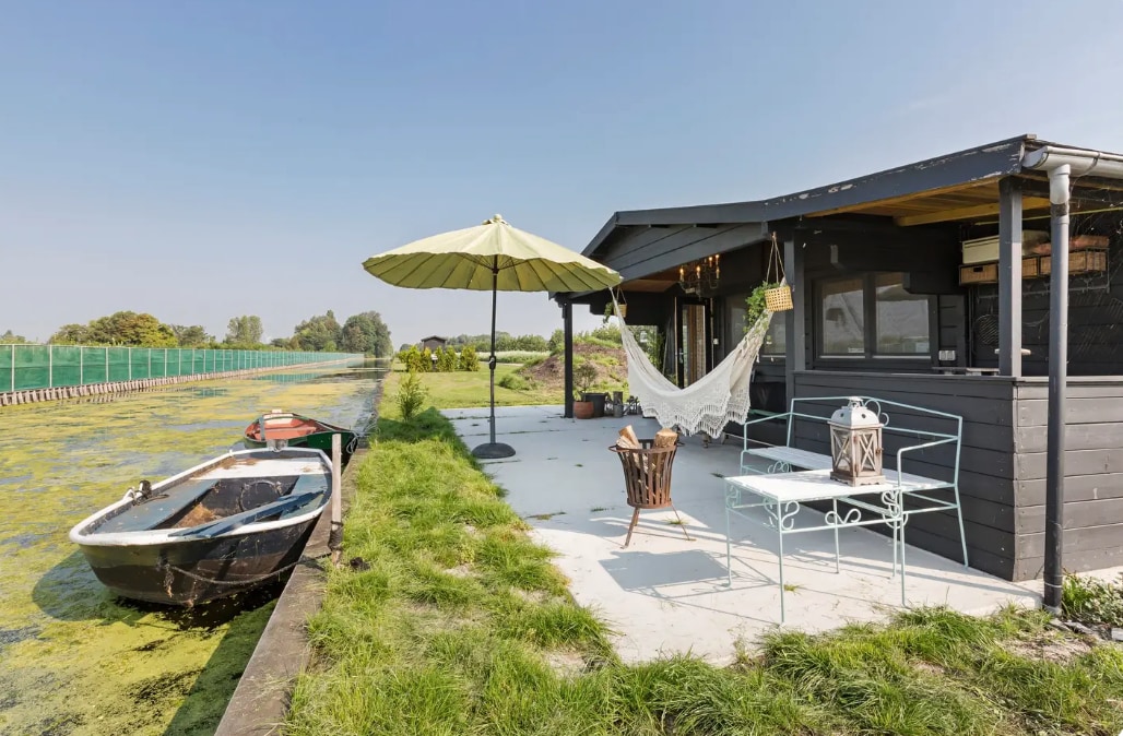 Wooden cabin with bikes and rowing boats