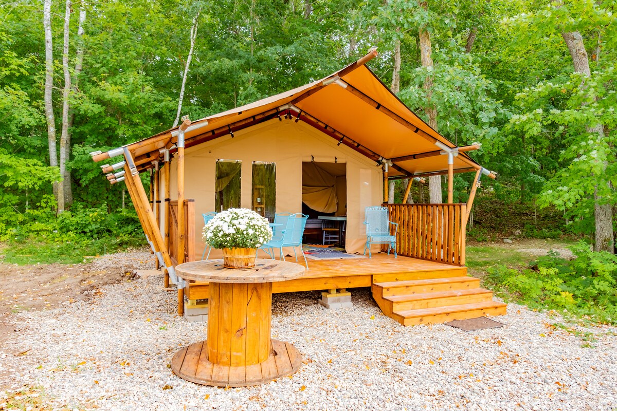 Cozy glamping safari tent at small lakeside resort