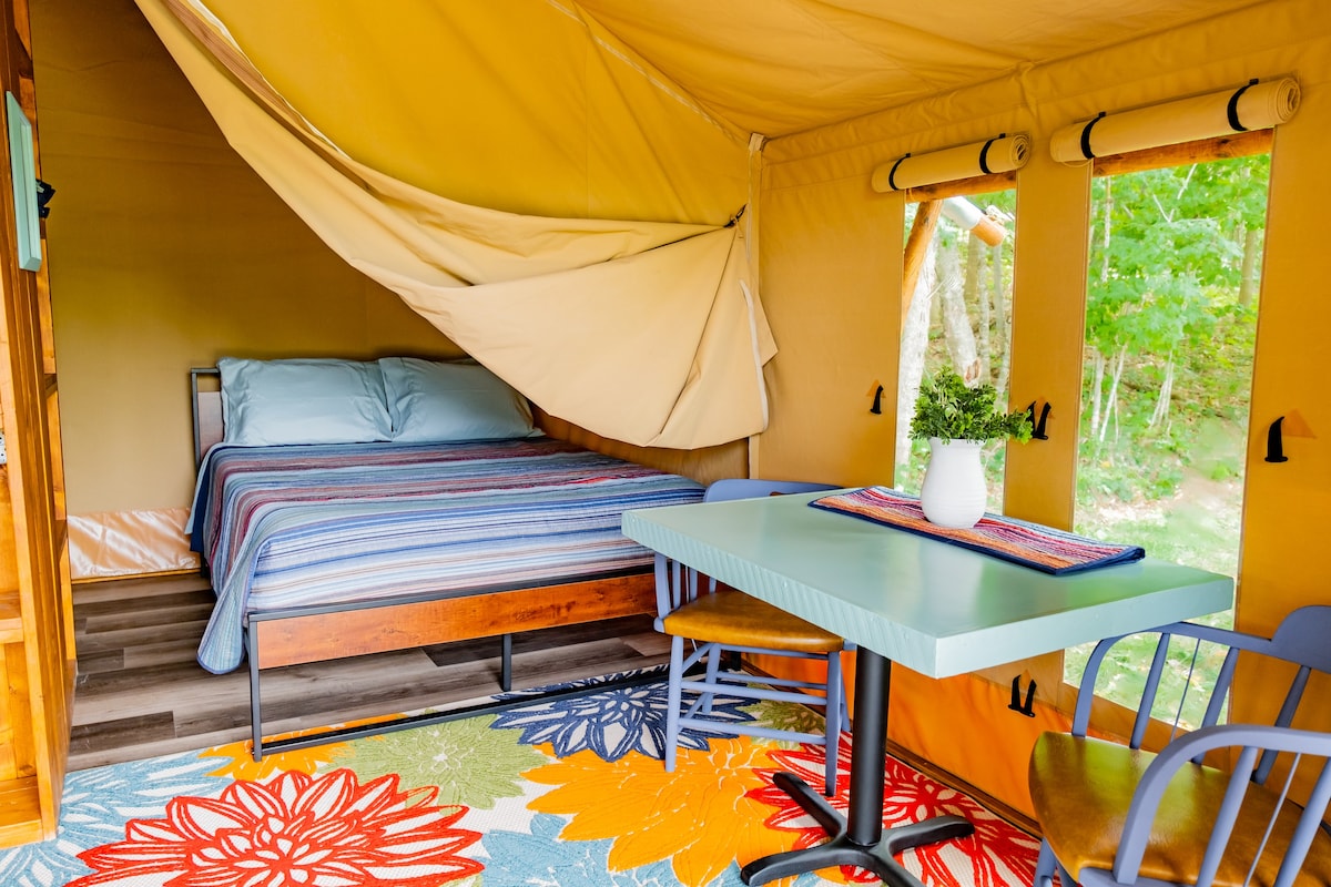Cozy glamping safari tent at small lakeside resort