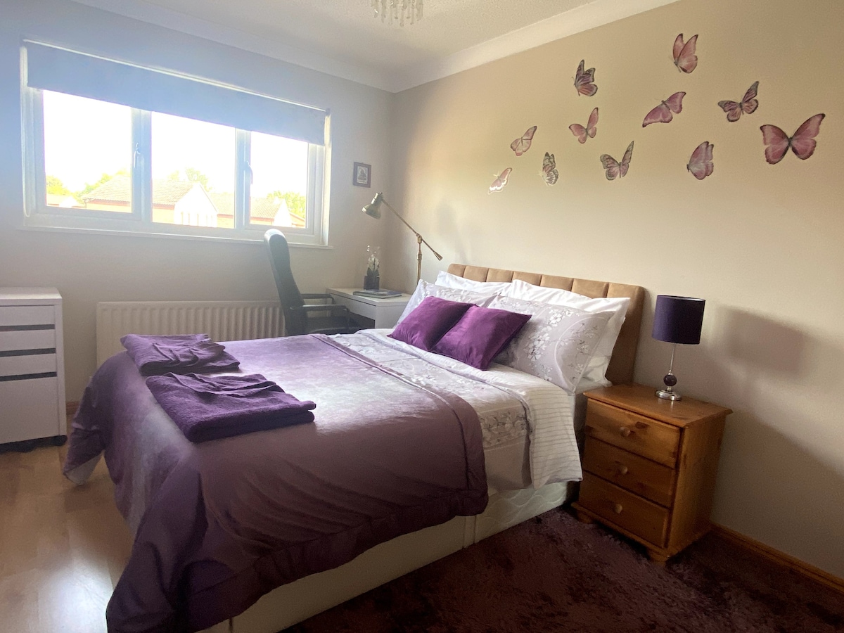 Purple Double Room with access to shared spaces.