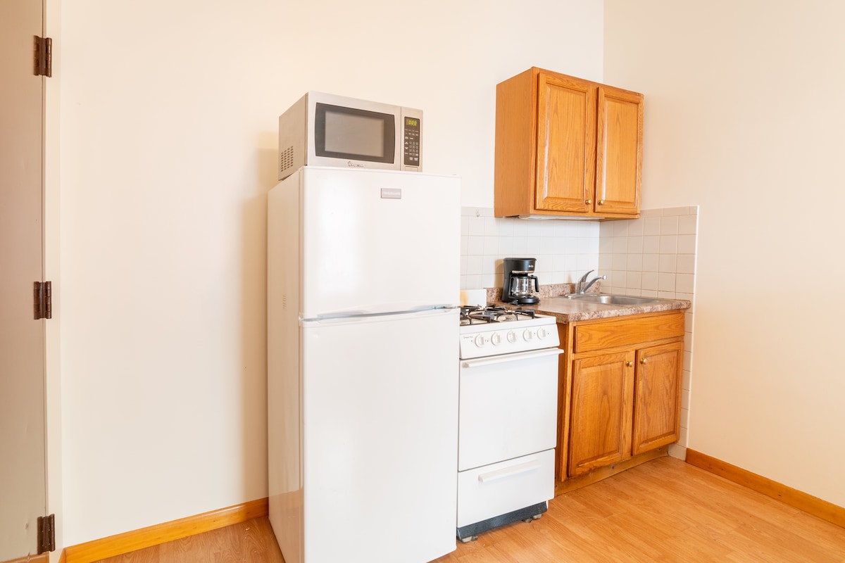 Spacious room with a kitchenette at West 30th St