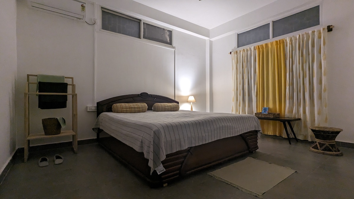 Modern, minimalist double-bed room with a library