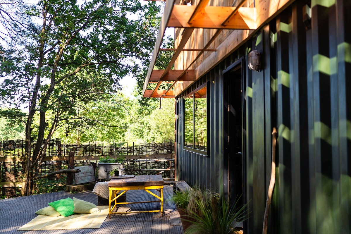 Unique shipping container cabin in private woods