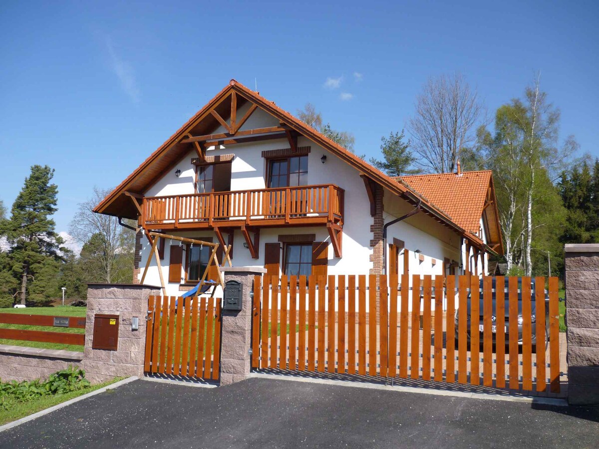Holiday home with fireplace, sauna and garden at L